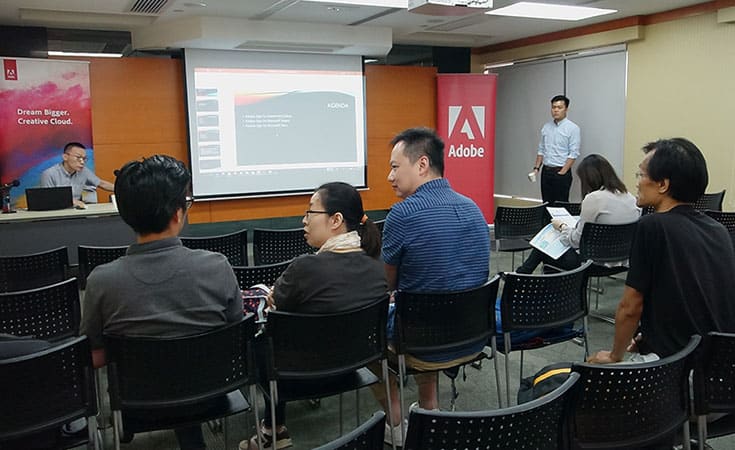 Guests are discussing the details of collaborative functions of Adobe and Microsoft products with the speaker
